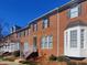Brick townhome with white trim and steps leading to the entrance at 121 Lumina Pl, Holly Springs, NC 27540