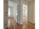 Hallway view with hardwood floors and white trim throughout the house at 121 Lumina Pl, Holly Springs, NC 27540