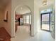 Bright kitchen with wooden cabinets, stainless appliances and white painted floors open to entryway and living spaces at 121 Lumina Pl, Holly Springs, NC 27540