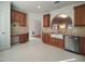 Spacious kitchen features stainless steel appliances, granite countertops, and an adjacent desk and cabinet area at 121 Lumina Pl, Holly Springs, NC 27540