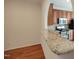 Kitchen with stainless steel appliances, wooden cabinets, and granite countertop peninsula at 121 Lumina Pl, Holly Springs, NC 27540