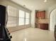 Eat-in kitchen area with bright windows and a built-in desk and cabinet space with bright white flooring at 121 Lumina Pl, Holly Springs, NC 27540