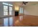Bright living room featuring a fireplace, hardwood flooring, and large windows at 121 Lumina Pl, Holly Springs, NC 27540