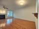 Bright living room featuring hardwood floors, fireplace, ceiling fan, and natural light at 121 Lumina Pl, Holly Springs, NC 27540