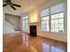 Living room featuring hardwood floors, fireplace, and large windows providing lots of light at 121 Lumina Pl, Holly Springs, NC 27540
