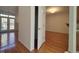 Open living room with hardwood floors, fireplace, French doors, and lots of natural light at 121 Lumina Pl, Holly Springs, NC 27540