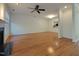 Open living room boasts hardwood floors, fireplace, and ceiling fan at 121 Lumina Pl, Holly Springs, NC 27540