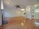 Spacious living room has hardwood floors, fireplace, and open design to kitchen at 121 Lumina Pl, Holly Springs, NC 27540