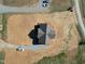 An aerial view of a gray roofed home surrounded by a large lot with dual driveways and several parked cars at 1820 Johnson Rd, Burlington, NC 27217