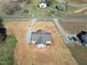 Aerial view of a one-story home with ample land and a gravel driveway at 1820 Johnson Rd, Burlington, NC 27217