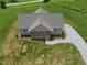 An aerial view of a charming home with a gravel driveway and a well-manicured lawn at 1820 Johnson Rd, Burlington, NC 27217