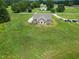 An aerial view displays a well-maintained home surrounded by lush greenery and multiple cars at 1820 Johnson Rd, Burlington, NC 27217