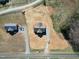 Aerial view of a home with a gray roof, long driveway, and ample land at 1820 Johnson Rd, Burlington, NC 27217
