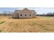Back exterior of home featuring neutral siding, windows, and outdoor space at 1820 Johnson Rd, Burlington, NC 27217