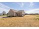 Back exterior of a home on large lot with rear door and small deck at 1820 Johnson Rd, Burlington, NC 27217