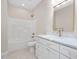 Bright bathroom featuring a tub/shower combo, a white vanity with marble countertop and gold fixtures at 1820 Johnson Rd, Burlington, NC 27217
