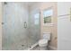 Stylish bathroom showcasing a glass shower with pebble floor and bright window at 1820 Johnson Rd, Burlington, NC 27217