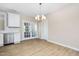 Open dining room features modern lighting, French doors and flows into the kitchen at 1820 Johnson Rd, Burlington, NC 27217