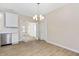 Open dining room features modern lighting, French doors and flows into the kitchen at 1820 Johnson Rd, Burlington, NC 27217