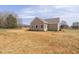 Side-back exterior view of a home with tan siding and a spacious lot at 1820 Johnson Rd, Burlington, NC 27217