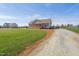 A single-story home with a gravel driveway surrounded by a sprawling green lawn at 1820 Johnson Rd, Burlington, NC 27217
