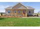 Charming single-story home with a welcoming front porch and a bright red front door at 1820 Johnson Rd, Burlington, NC 27217