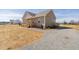 Exterior view of a home with a gravel driveway and a charming front porch at 1820 Johnson Rd, Burlington, NC 27217