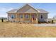 Charming single-story home with a covered front porch and a bright red front door at 1820 Johnson Rd, Burlington, NC 27217