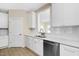 Bright kitchen features white cabinets, subway tile backsplash, quartz counters and stainless appliances at 1820 Johnson Rd, Burlington, NC 27217
