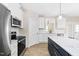 Well-appointed kitchen with stainless steel appliances and sleek cabinetry and an island with seating at 1820 Johnson Rd, Burlington, NC 27217