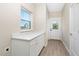 Functional mud room with white storage cabinets, and exterior door at 1820 Johnson Rd, Burlington, NC 27217