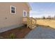 Side entrance view with wooden stairs, gravel walkway, and tidy landscaping at 1820 Johnson Rd, Burlington, NC 27217