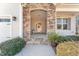 Inviting front porch entry with stone columns and landscaping at 201 Laurel Oaks Dr, Youngsville, NC 27596