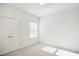 Bright bedroom featuring a window with blinds and double doors at 2029 Maggie Valley Dr, Apex, NC 27502