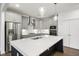 Modern kitchen with stainless steel appliances and white cabinets at 2029 Maggie Valley Dr, Apex, NC 27502
