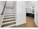 Stylish staircase leading to upper level with kitchen view at 2029 Maggie Valley Dr, Apex, NC 27502