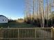 View from deck showcases grassy backyard and treeline at 228 Mahogany Way, Four Oaks, NC 27524