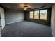 Spacious bedroom with carpet, ceiling fan, and multiple windows at 228 Mahogany Way, Four Oaks, NC 27524