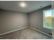Simple bedroom with carpet, window, and neutral walls at 228 Mahogany Way, Four Oaks, NC 27524