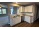 Kitchen with white cabinets, granite countertops and stainless steel dishwasher at 228 Mahogany Way, Four Oaks, NC 27524