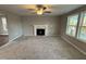 Living room with fireplace, neutral walls, and ceiling fan at 228 Mahogany Way, Four Oaks, NC 27524