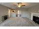 Open living area with a view into the kitchen and a fireplace at 228 Mahogany Way, Four Oaks, NC 27524