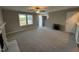 Spacious living room featuring carpet, fireplace, and ceiling fan at 228 Mahogany Way, Four Oaks, NC 27524