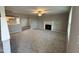 Open living room with fireplace and kitchen view at 228 Mahogany Way, Four Oaks, NC 27524