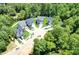 An aerial view of a home community featuring well-maintained homes and plentiful trees at 2628 Silver Gate Ct, Wake Forest, NC 27587