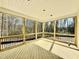 Screened back porch with wooded views and tongue-and-groove ceiling at 2628 Silver Gate Ct, Wake Forest, NC 27587