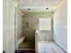 Bathroom featuring a tiled shower with bench and a large window at 2628 Silver Gate Ct, Wake Forest, NC 27587
