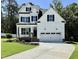 Charming two-story home with a black door, black shutters and a well-manicured lawn at 2628 Silver Gate Ct, Wake Forest, NC 27587