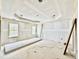 Unfinished main bedroom with decorative tray ceiling and large windows at 2628 Silver Gate Ct, Wake Forest, NC 27587