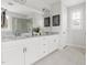 Bright bathroom featuring a double sink vanity, a large mirror, neutral granite countertops, and a glass shower at 296 Two Creeks Lp, Chapel Hill, NC 27517